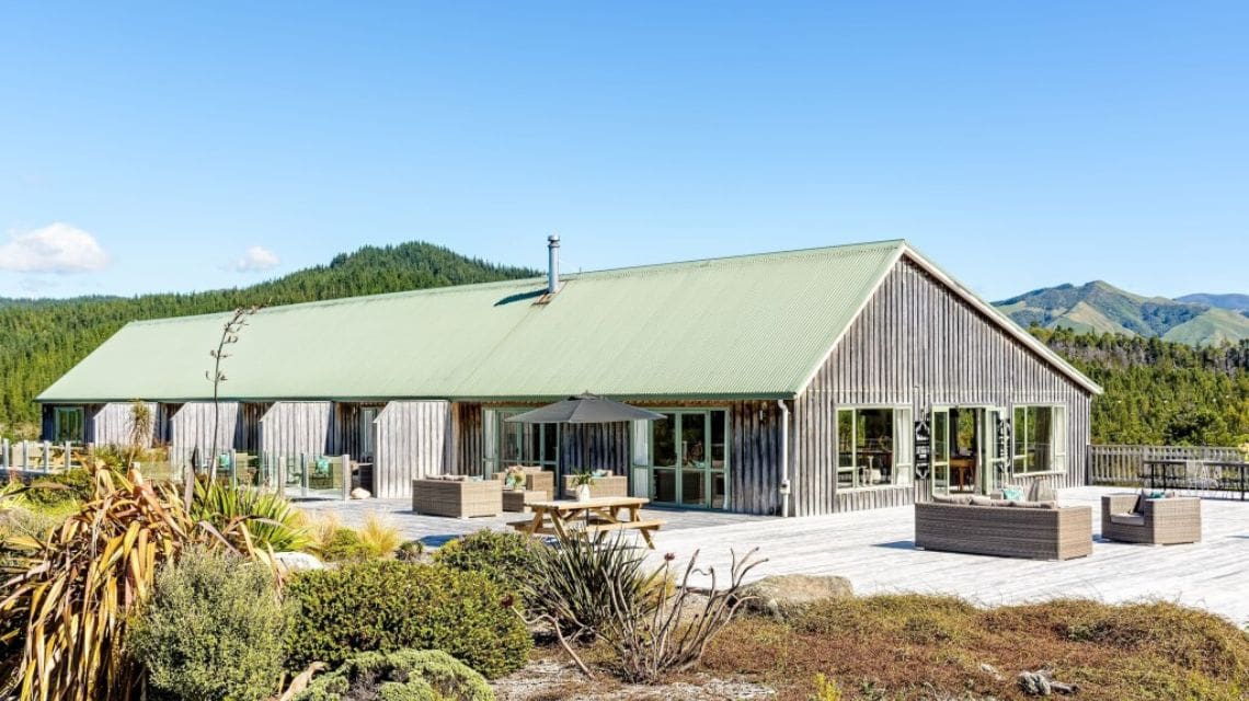 Exterior view of a lodge accommodation with native vegetation in the foreground