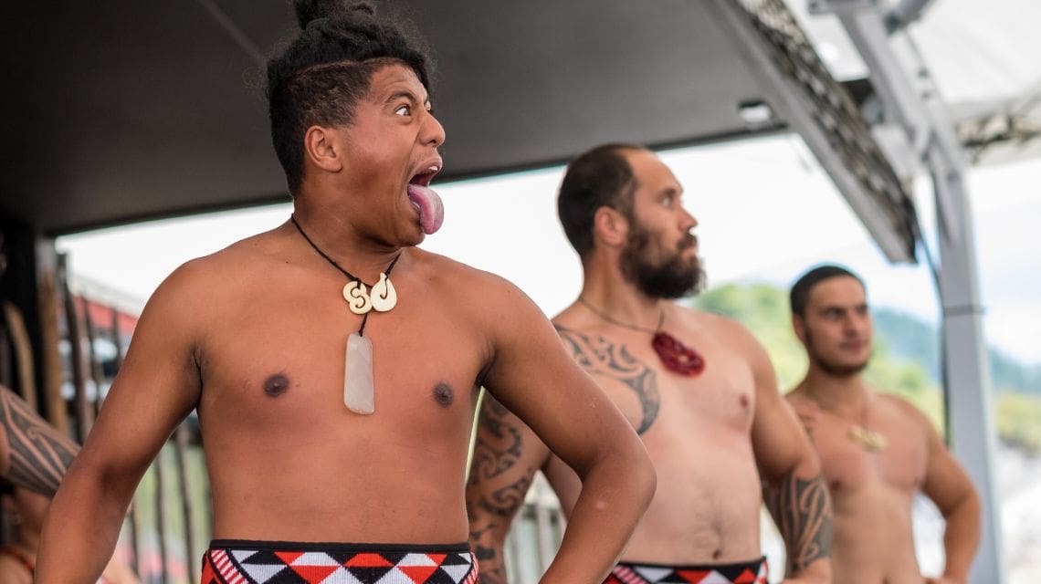 Three Maori men performing the Haka warrior dance