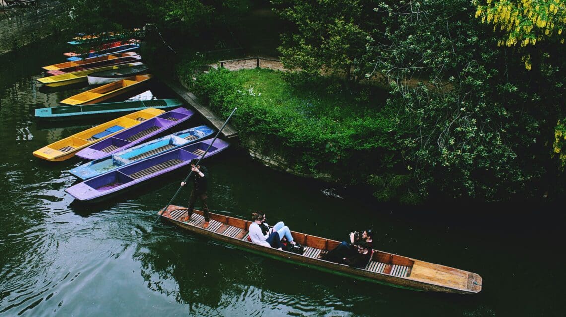 people in a boat punting on a river