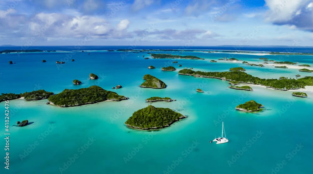 A spectacular  drone  image over Falaga Island in the lower Lau Group, Fiji showing a catamaran peacefully at anchor.