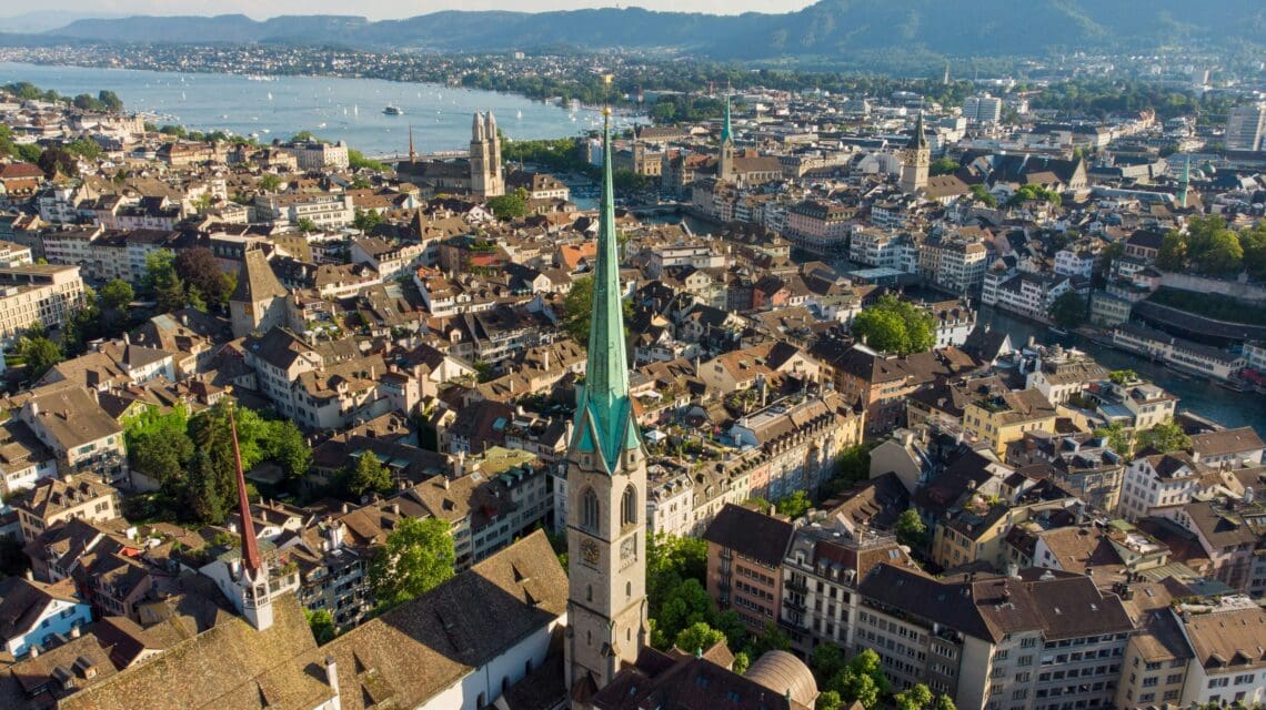 aerial view of Zurich skyline showing church tower, old town and lake.