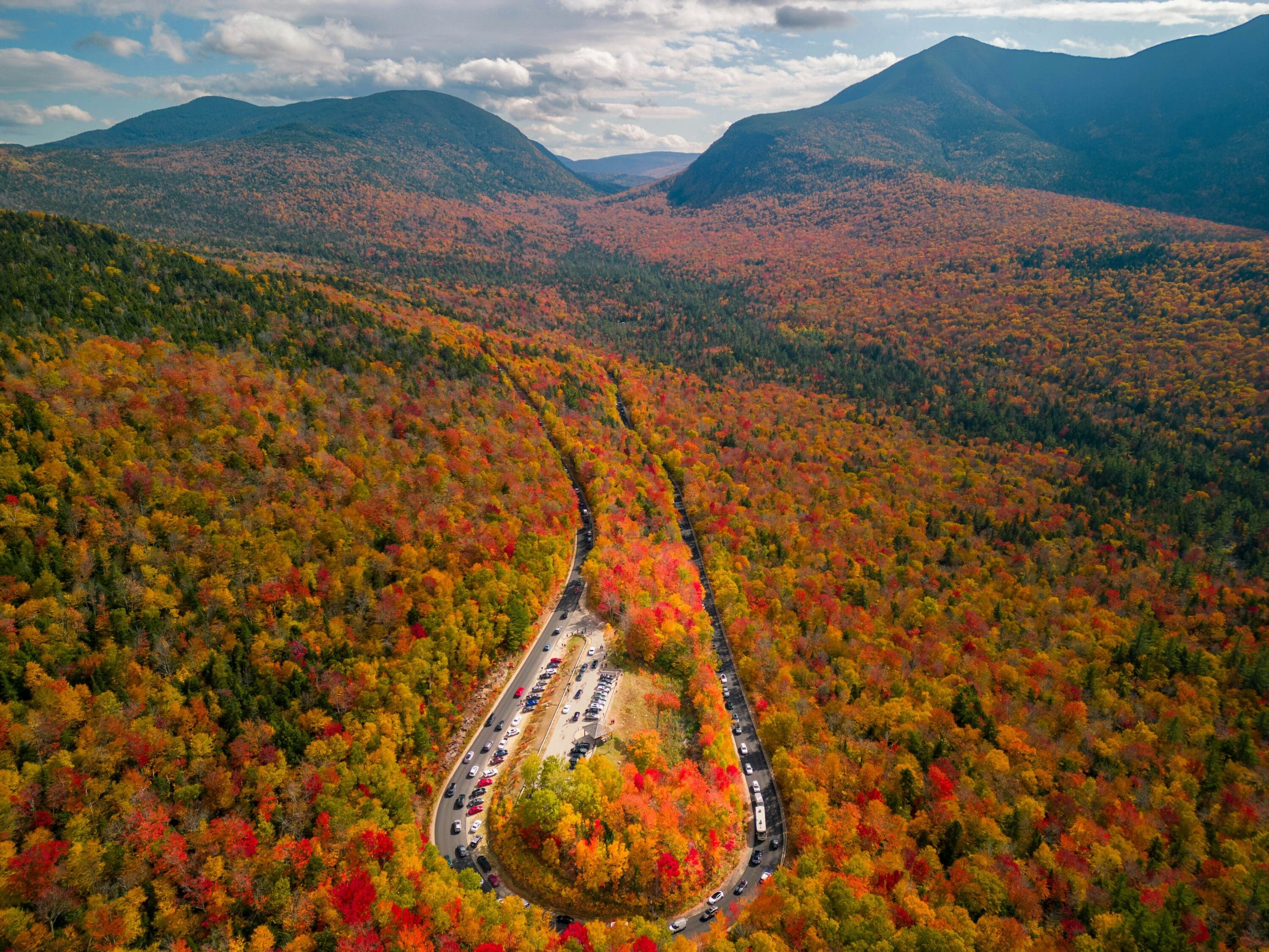 An aerial shot of Kancamagus Highway in New Hampshire during peak foliage season.