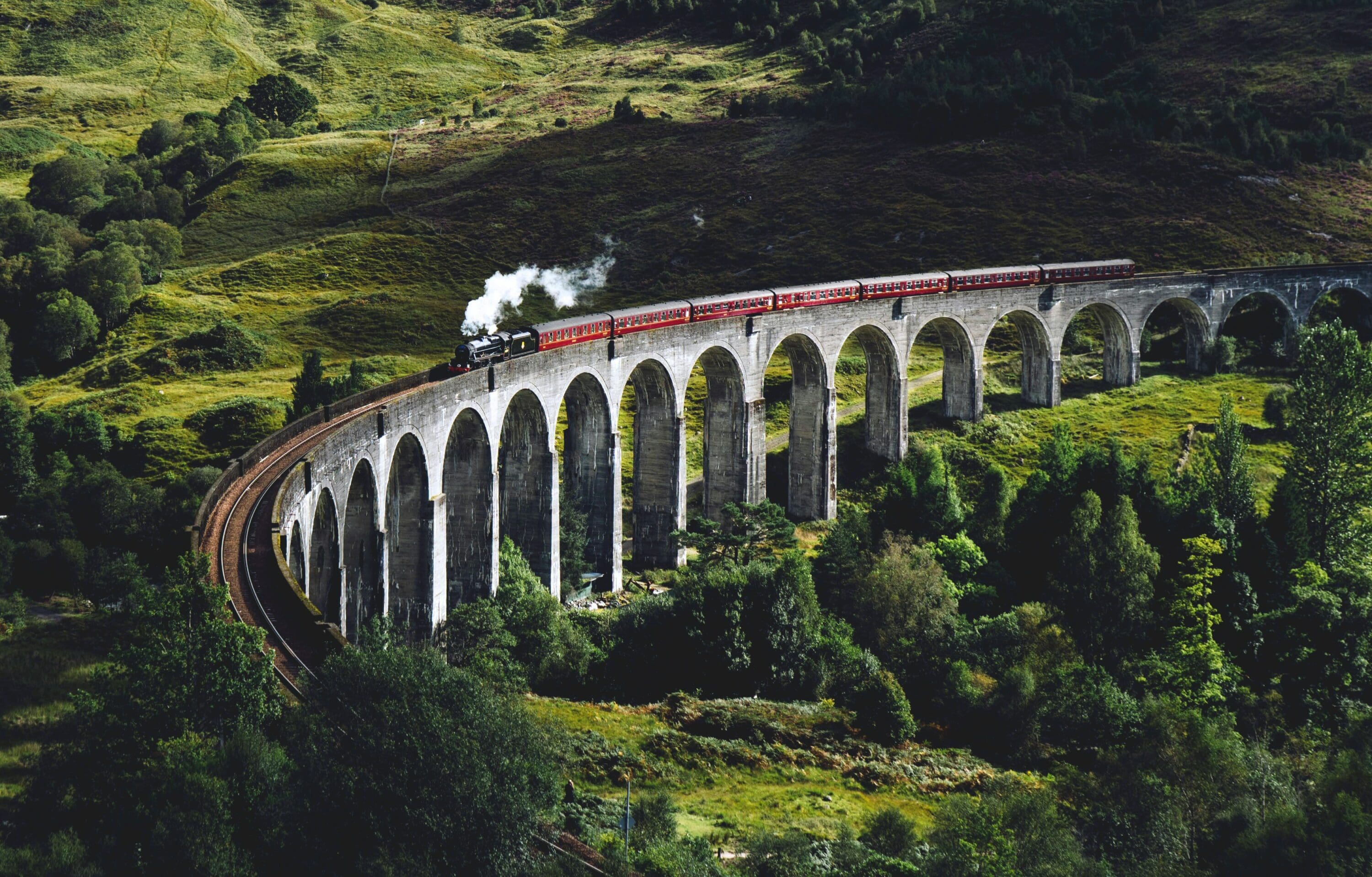 Train traveling over a viaduct in the countryside