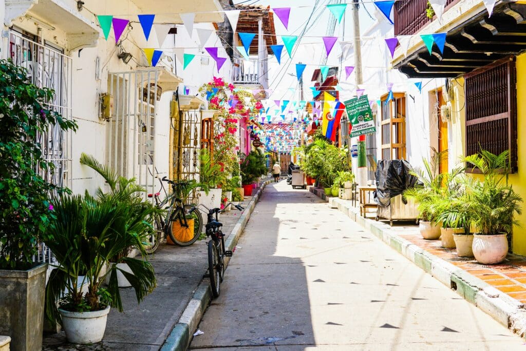 Colorful street with flags drapped between buildings